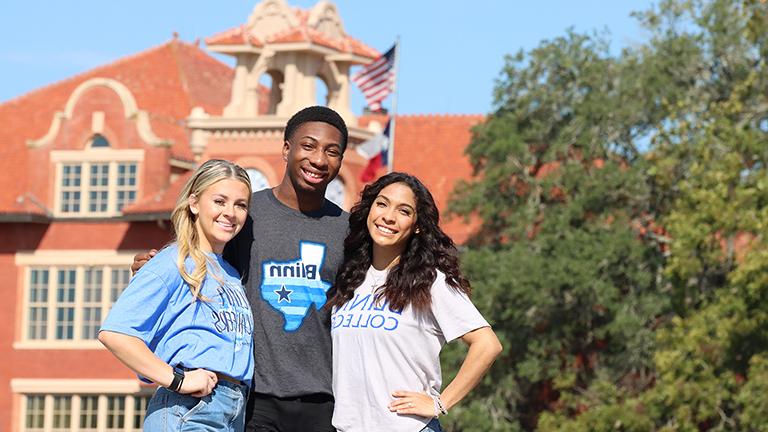 Three Students In Front of Old Main Building